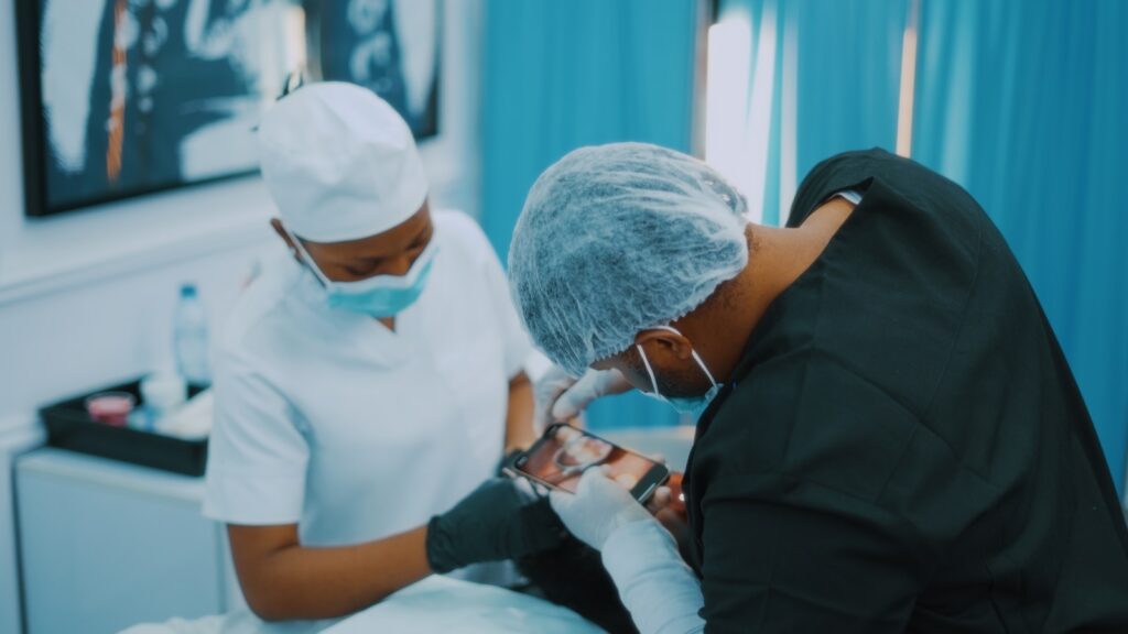 a man getting his teeth checked by a dentist